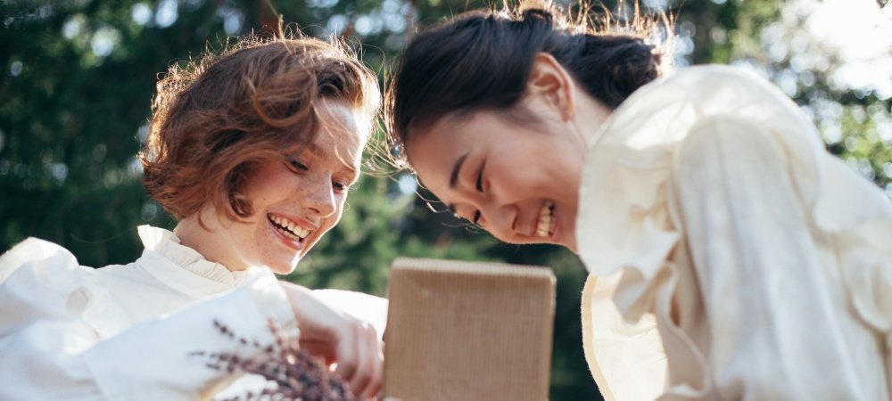 Zwei Frauen lachen und unterhalten sich, tiefgründige Gespräche