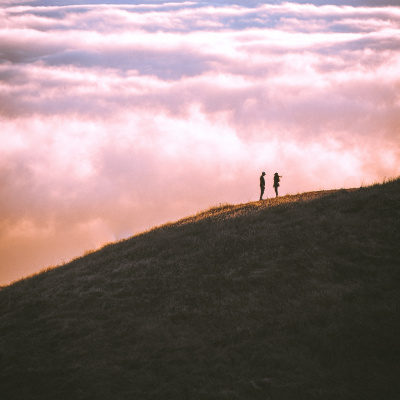 Ein Paar steht sich auf einem Hügel gegenüber