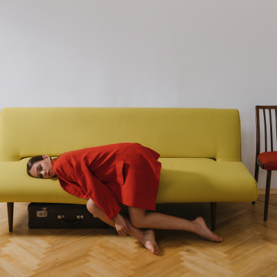 Trennung verarbeiten: Frau liegt auf dem Sofa
