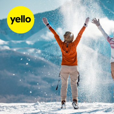 Drei junge Frauen vor Bergkulisse werfen Schnee in die Luft